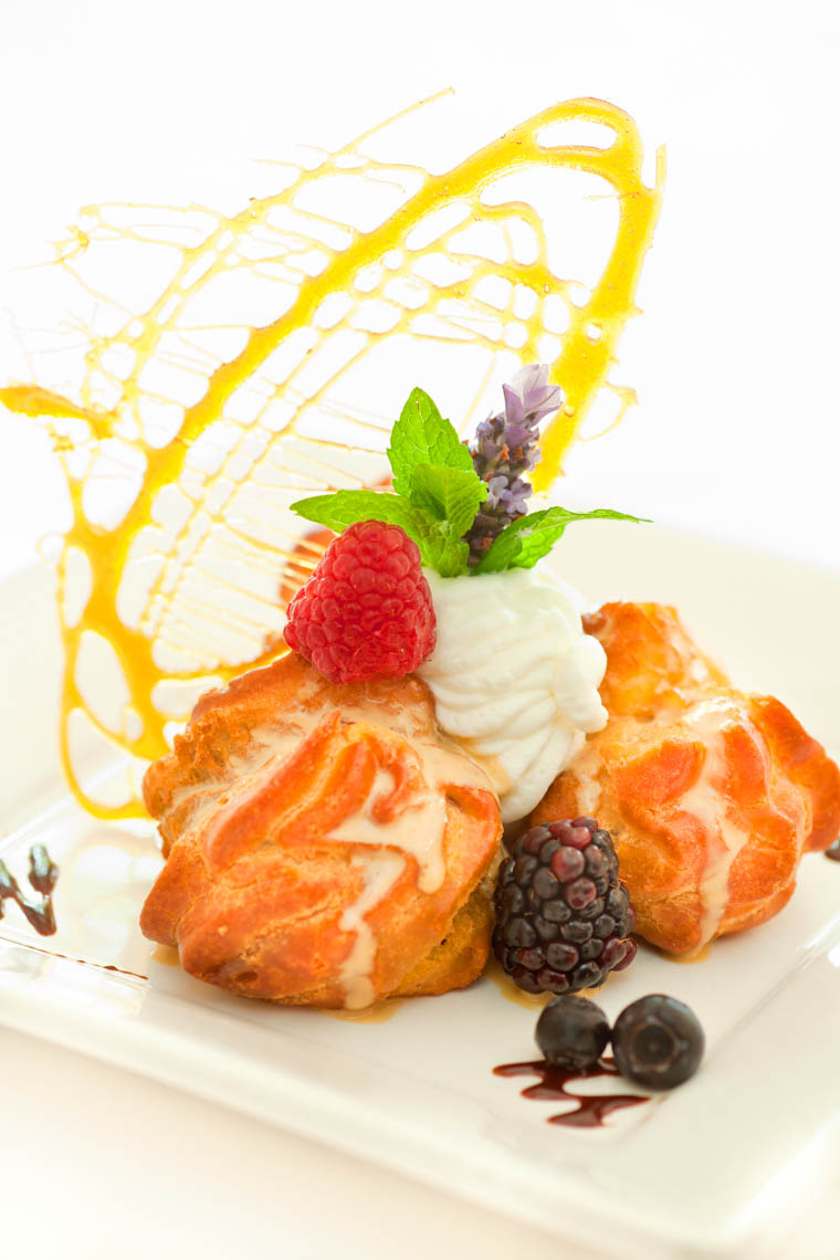 profiteroles au chocolat, chocolate ganache filled cream puff with mocha sauce, whipped creme and carmel angel hair